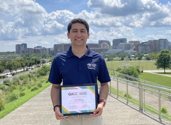 Said Gomez pictured holding the Jack Mangham Experiential Learning Award.